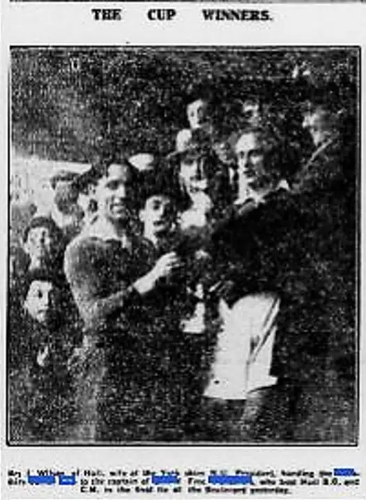 Black and white paper cutting with photo of the 1920s Captain being handed the Junior Cup