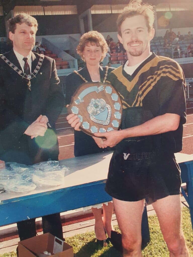 old photo of Captain Adam Olroyd accepting medal