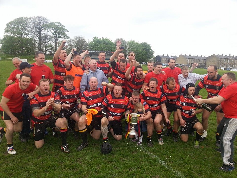 Brighouse team celebrating a win, holding the Fee cup in 2014