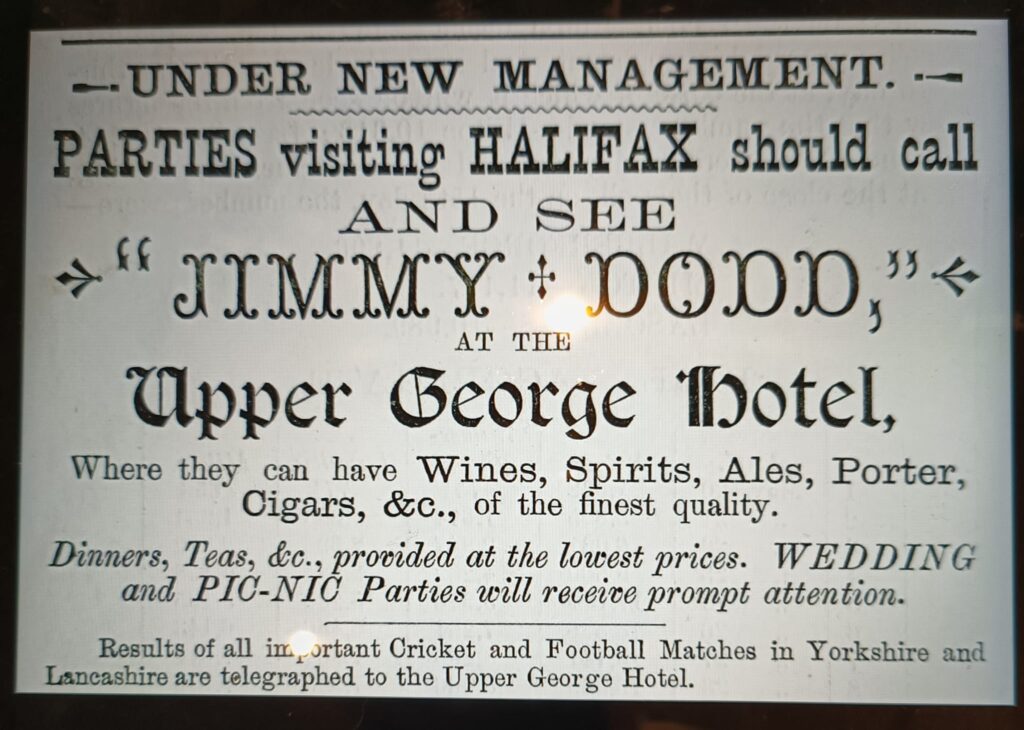 Photo of an 'under new management' sign for the Upper George Hotel