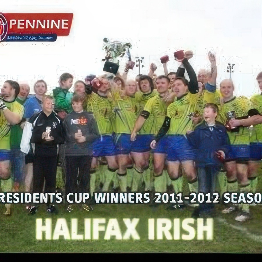 photo of team members wearing light green kits and blue shorts celebrating