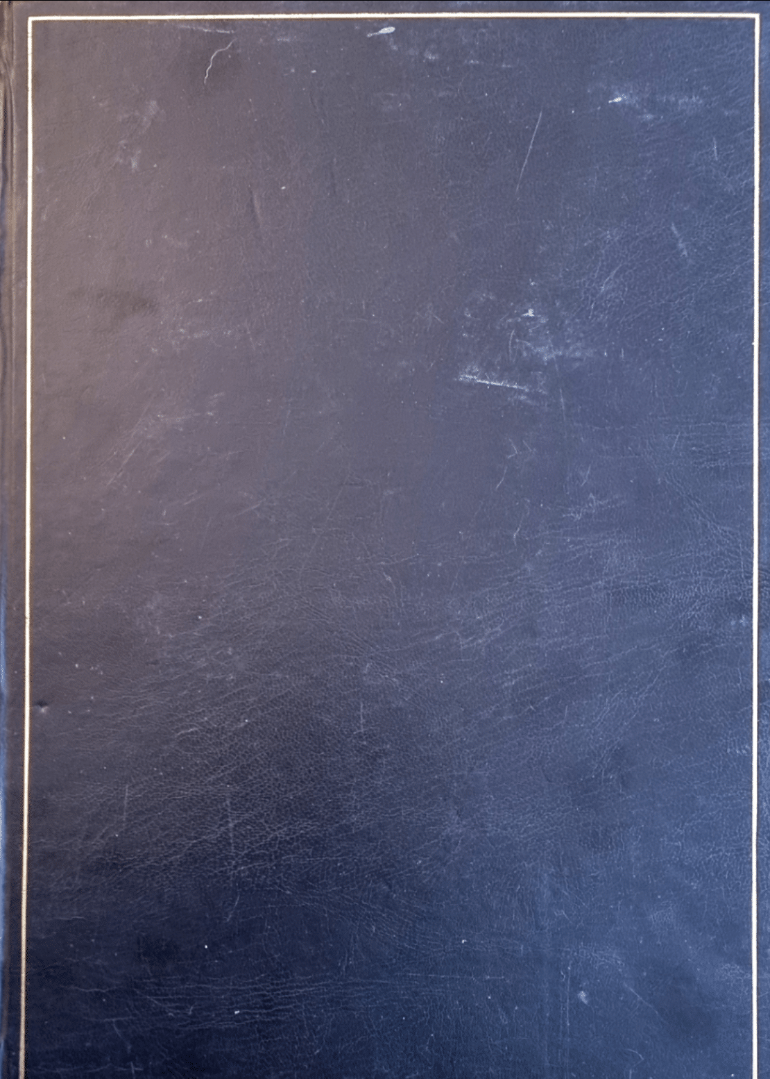scan of front cover of scrapbook, which is made of a blue leather-look material