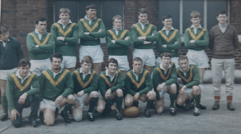old colour photograph of the 1968 St Marys team, two rows of players wearing green and yellow kits with white shorts
