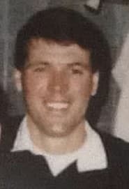 colour photo of Jim Smith who has short, dark hair and is smiling 