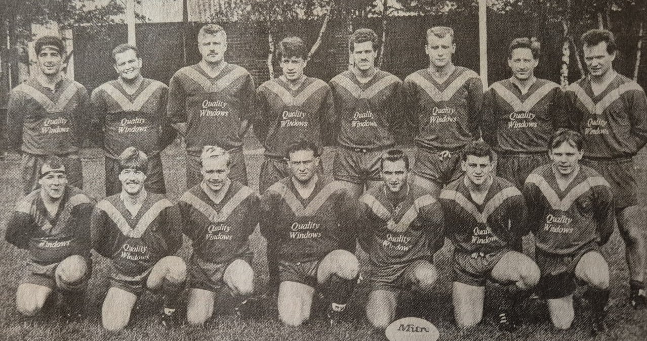 black and white team photo of players in two rows, wearing kits which said "quality windows" over the chest, all players have their arms behind their backs