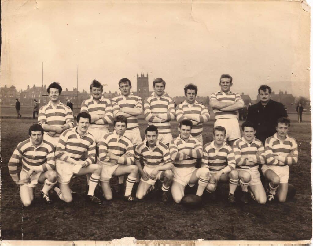 old sepia photo of a team on the field, in two rows, wearing their stripey kits
