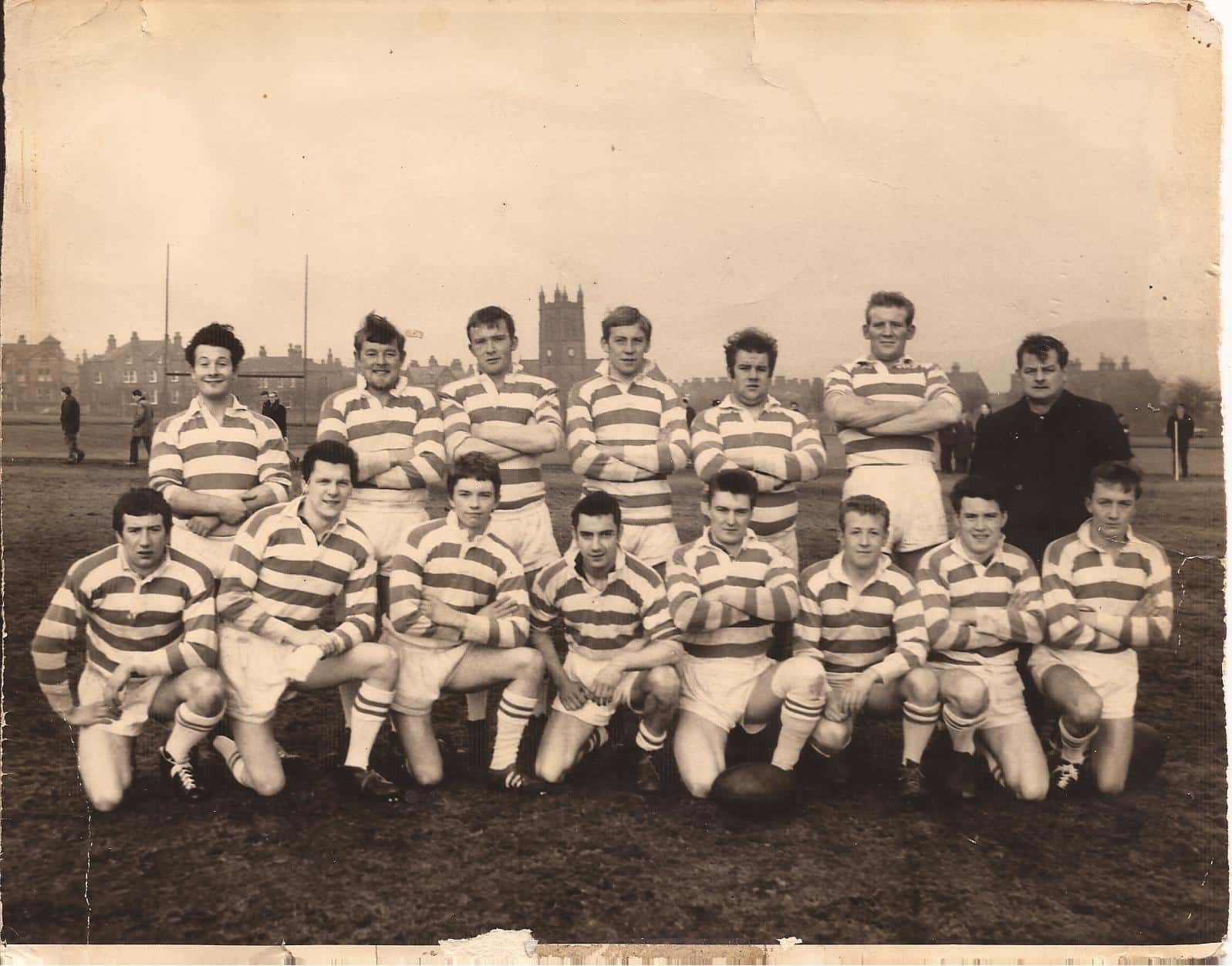 old sepia photo of a team on the field, in two rows, wearing their stripey kits