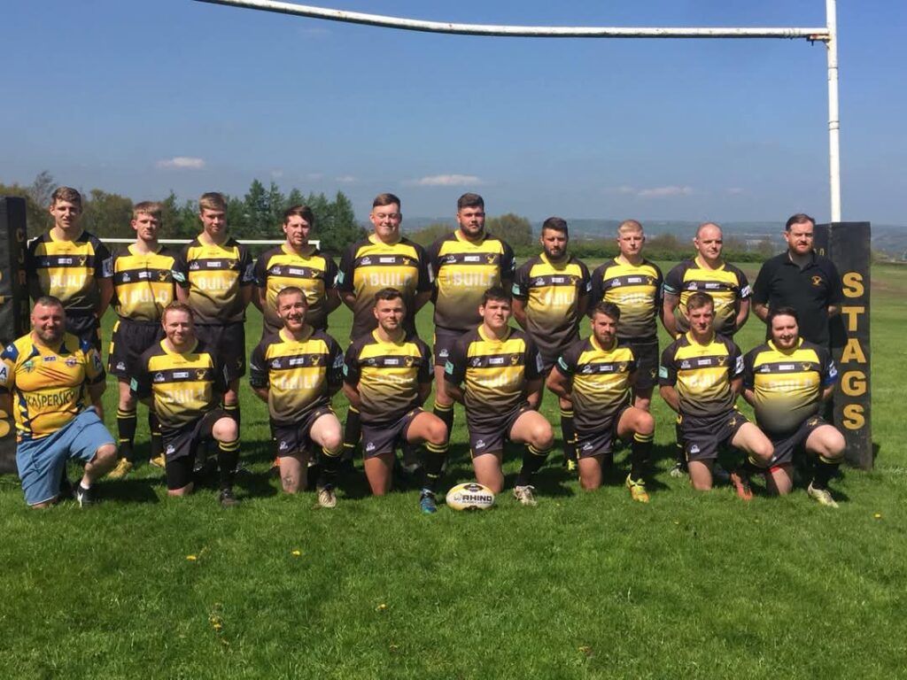 colour tram photo, in two rows on the pitch, in their kits, in front of the goal posts