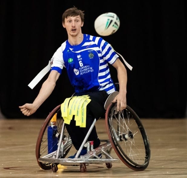colour action shot photo of Jack Brown, who is wearing their kit, about to catch the ball which is in mid-air