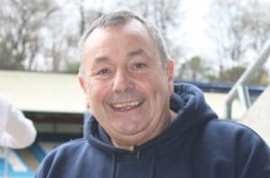 colour headshot photo of Malcolm Kielty M.B.E smiling to the camera, wearing a navy hoodie