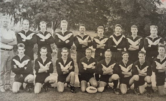 black and white photo of Boothtown Terriers team in the 1980s, two rows of players with their arms crossed, on the pitch, wearing their kits
