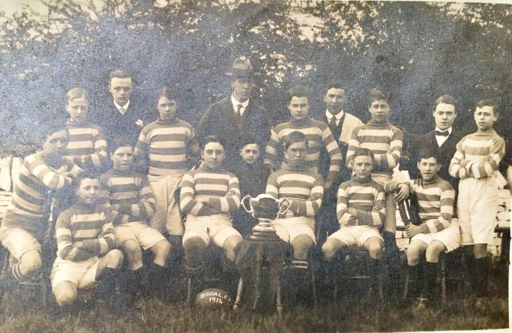 black and white photo of Siddal Evening School in 1914, with two rows of young players wearing stripey kits