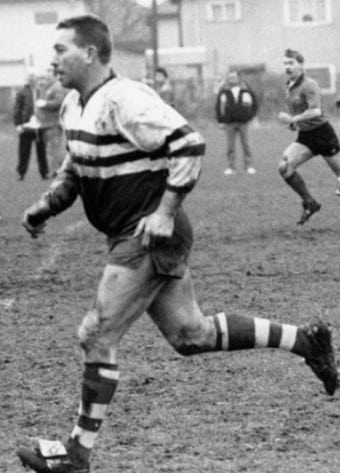 black and white photo of a player running