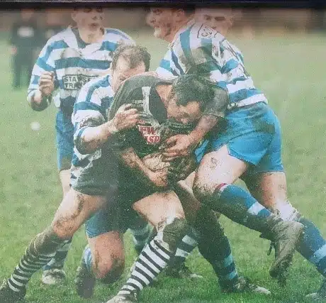 colour action shot of five players tackling for the ball in the 1980s