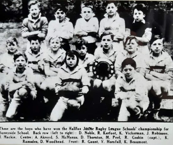 black and white newspaper clipping photo of Sunnyside school team in the 1960s holding the trophy plate, with names in text below the photo
