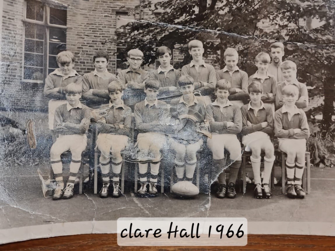 black and white team photo with players wearing their kits, organised in two rows, the photo says "clare Hall 1966" at the bottom in the middle 